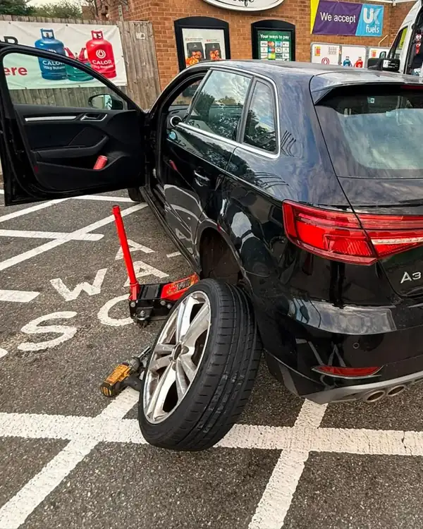 Audi A3 tyre replaced on a forecourt