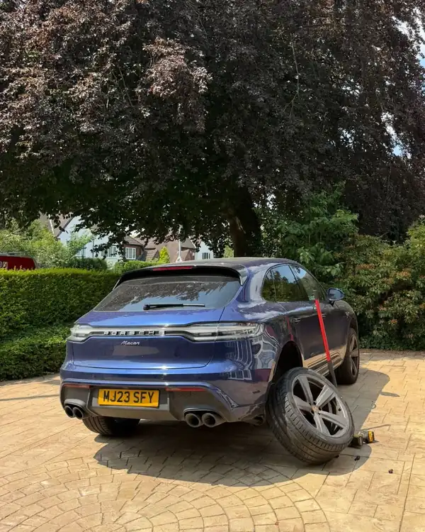 Porsche Macan with a new tyre fitted on the driveway